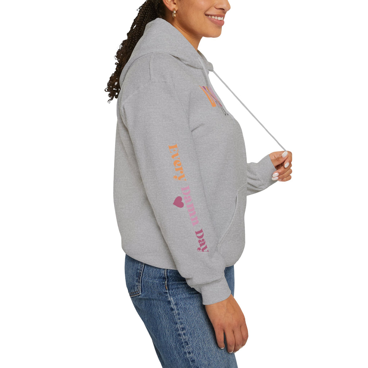 Person wearing a gray hoodie with sleeve 'EVERY DAMN DAY', paired with blue jeans, shown from a side profile against a white background.