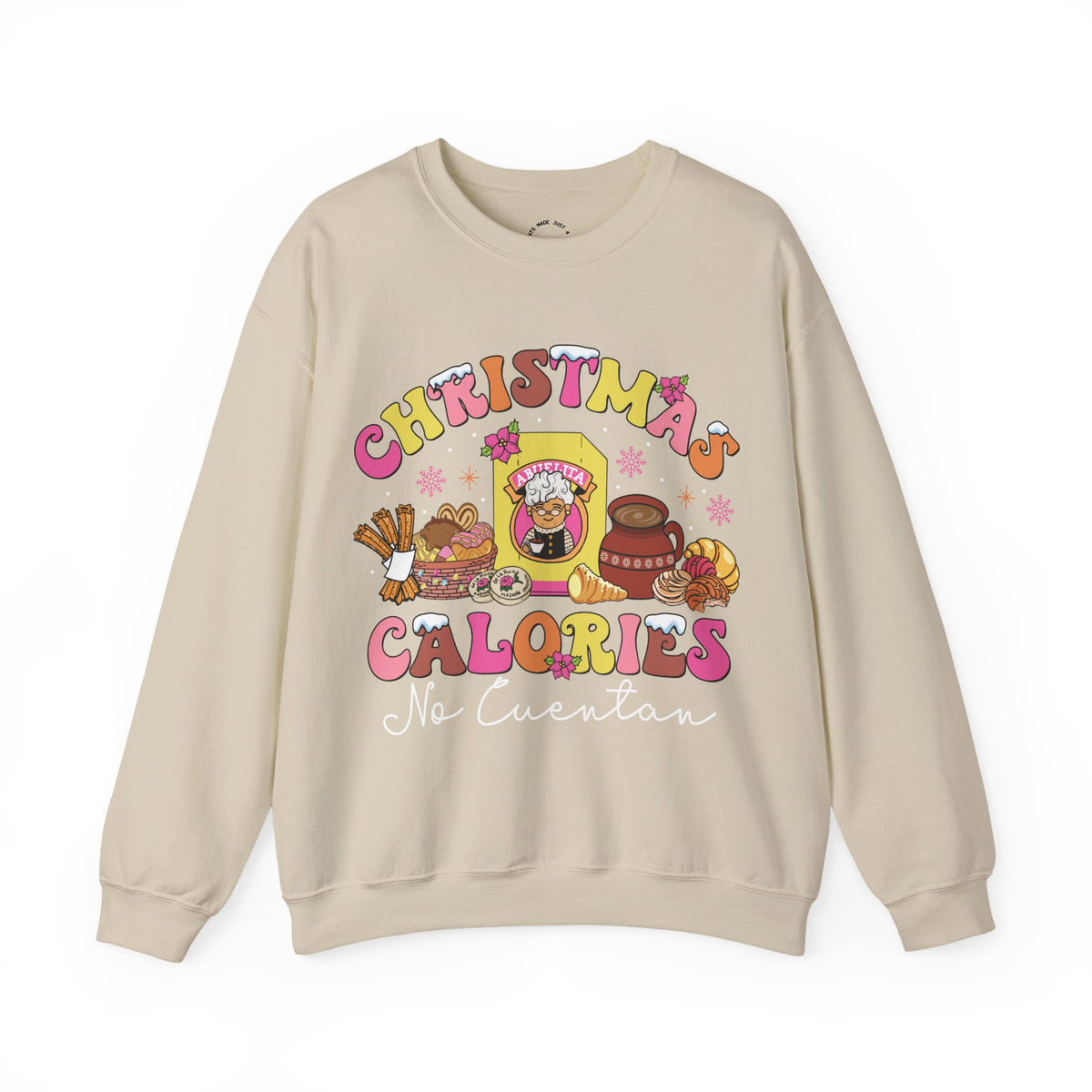 A beige crewneck sweatshirt featuring a colorful graphic print on the front with the text 'CHRISTMAS CALORIES No Cuentan' and cartoon illustrations of a candy corn, a hot chocolate cup, and a donut.
