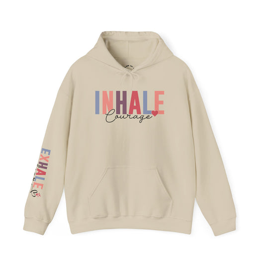 A beige pullover hoodie with 'INHALE Courage' printed across the chest in a multicolor block-letter design, and 'EXHALE fear' printed vertically on the right sleeve.