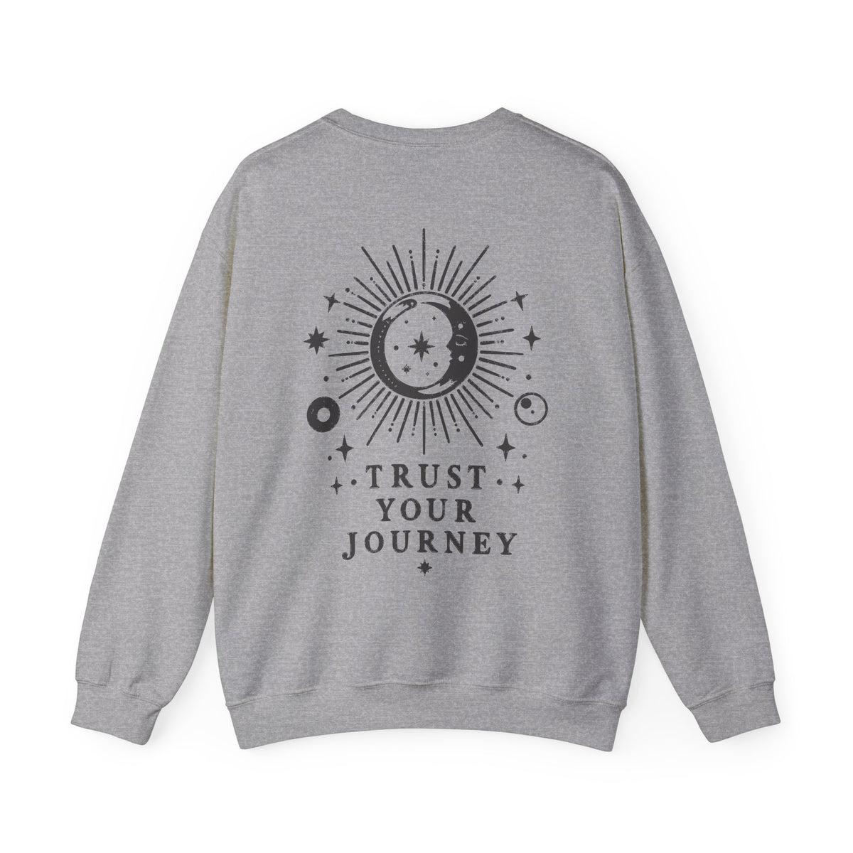 A heather gray crewneck sweatshirt shown from the back, featuring a black celestial graphic with a sun, moon, stars, and the text 'TRUST YOUR JOURNEY'.