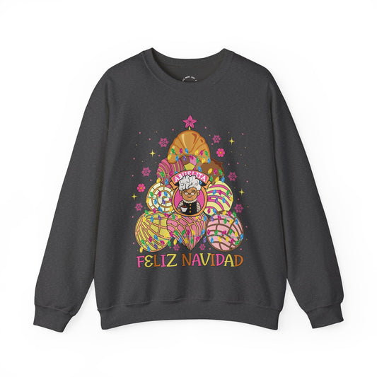 A dark gray crewneck sweatshirt featuring a colorful graphic of Abuelita in a festive, patterned concha christmas tree with the text 'FELIZ NAVIDAD' printed below, displayed on a clean white background.