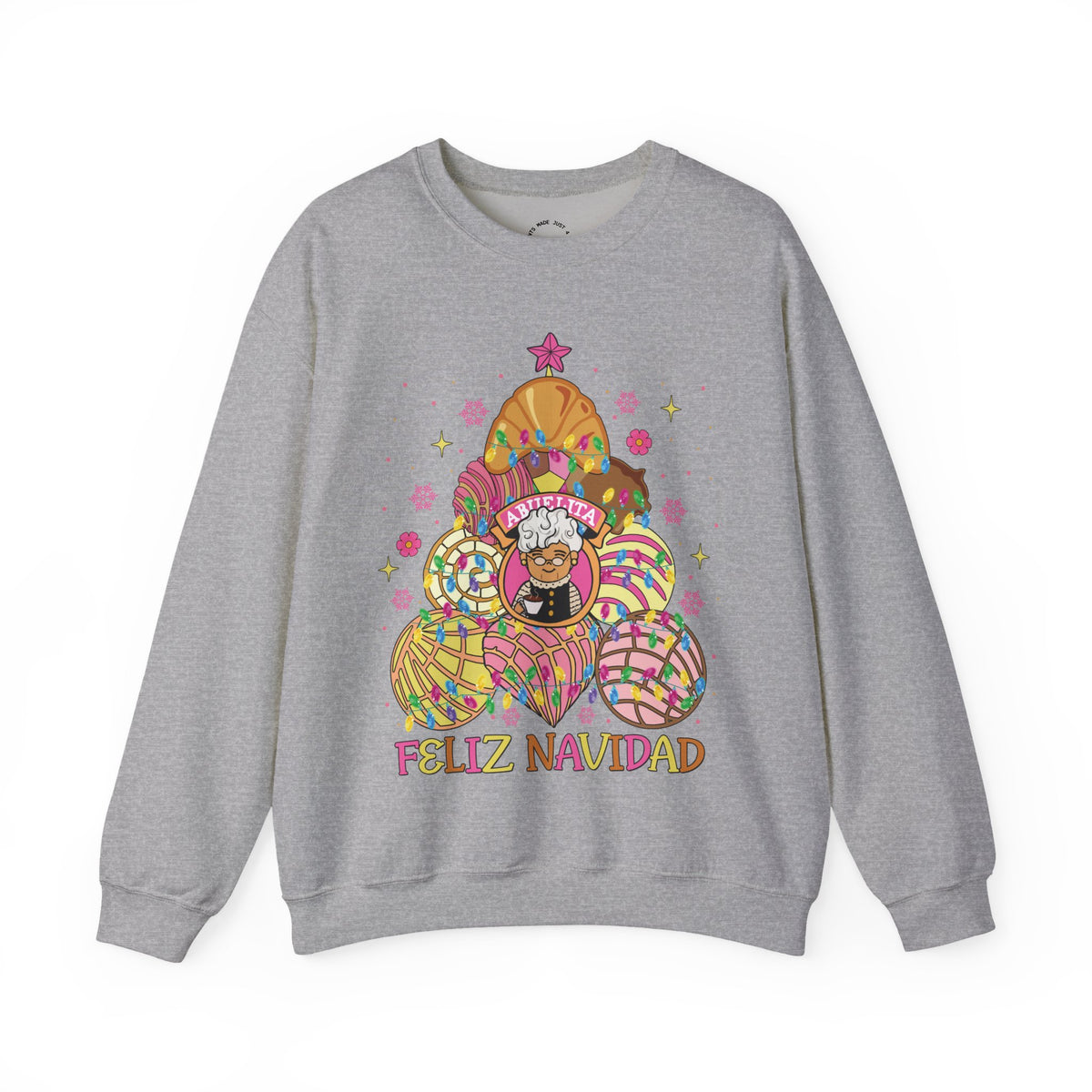 A light gray crewneck sweatshirt featuring a colorful graphic of Abuelita in a festive, patterned concha christmas tree with the text 'FELIZ NAVIDAD' printed below, displayed on a clean white background.