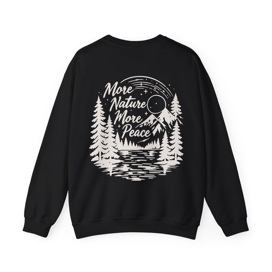 A black crewneck sweatshirt with a cream graphic print on the back featuring pine trees, mountains, a lake, and the text 'More Nature More Peace' inside a circular design.