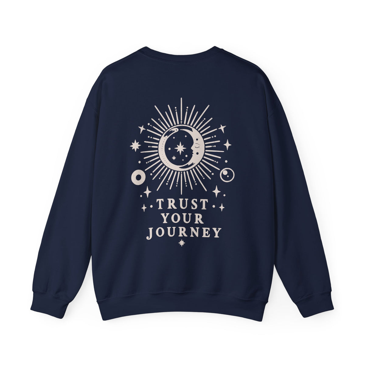 A navy blue crewneck sweatshirt shown from the back, featuring a cream-colored celestial graphic with a sun, moon, stars, and the text 'TRUST YOUR JOURNEY'.