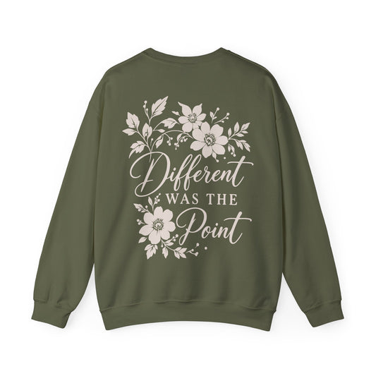 An olive green crewneck sweatshirt shown from the back, featuring a cream graphic print with floral illustrations and the text 'Different WAS THE Point'.