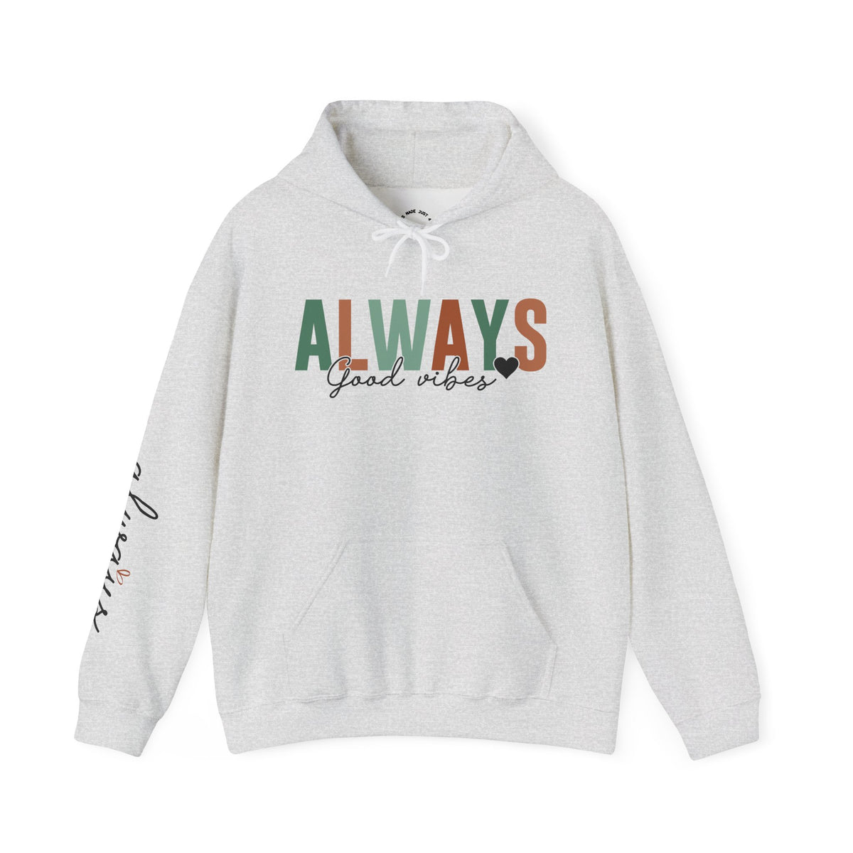 A light heather gray pullover hoodie with a front kangaroo pocket and drawstring hood, featuring the word 'ALWAYS' in block letters with 'Good vibes' in black script underneath with a solid small heart. The left sleeve has a vertical script graphic 'ALWAYS GOOD ENERGY'.