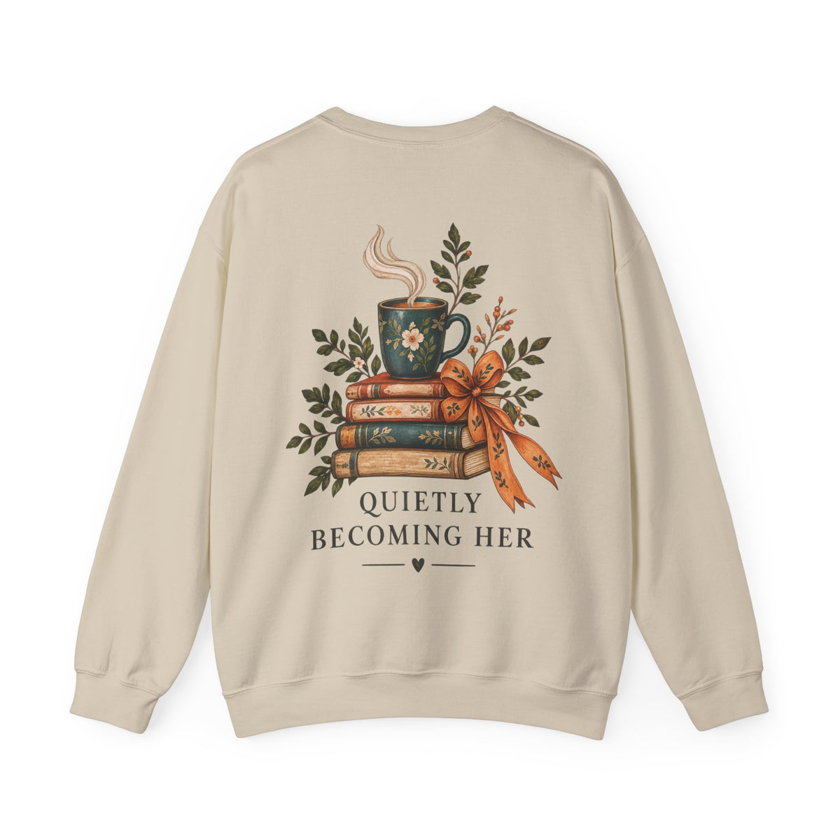 A beige crewneck sweatshirt shown from the back, featuring a graphic of a steaming mug on a stack of books tied with a ribbon, surrounded by green leaves, with the text 'QUIETLY BECOMING HER'.