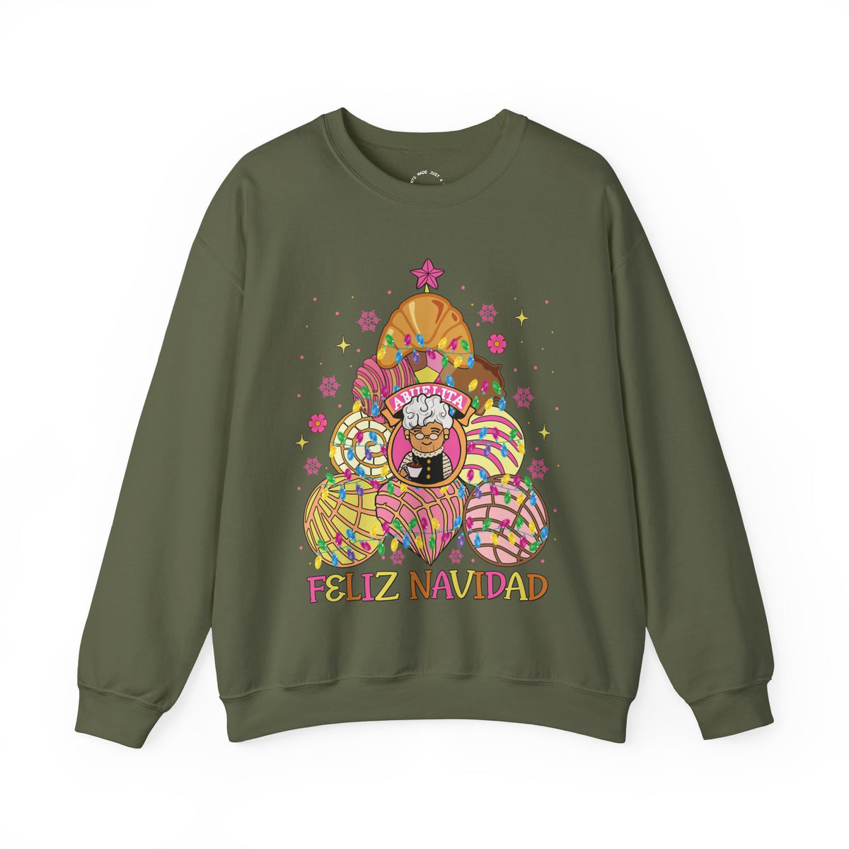 A military green crewneck sweatshirt featuring a colorful graphic of Abuelita in a festive, patterned concha christmas tree with the text 'FELIZ NAVIDAD' printed below, displayed on a clean white background.