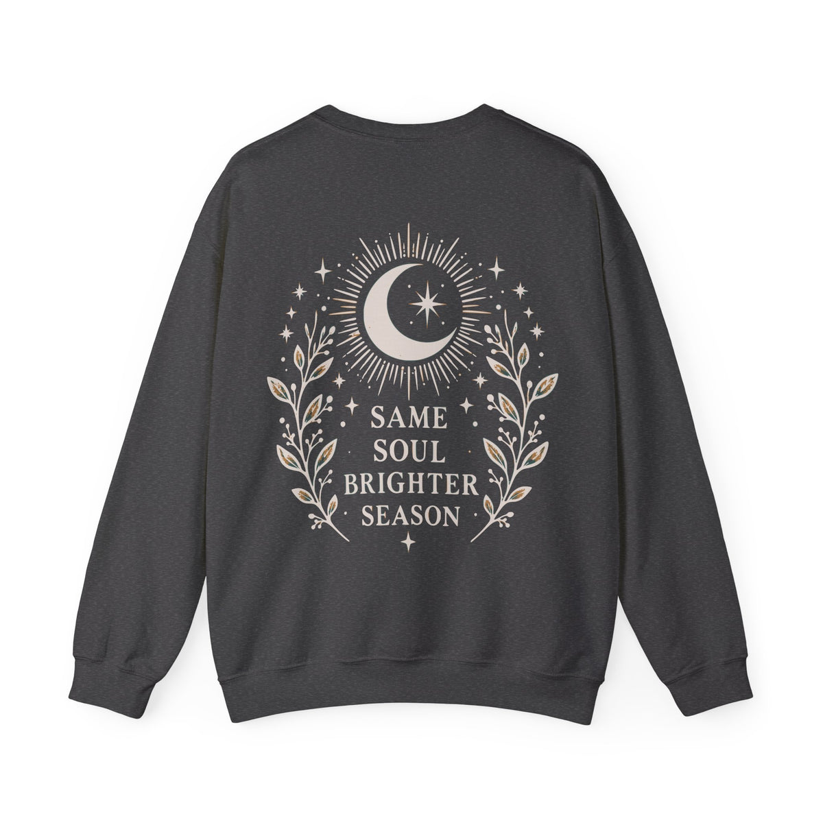A dark charcoal gray crewneck sweatshirt shown from the back, featuring a celestial graphic with a crescent moon, stars, and leafy branches surrounding the text 'SAME SOUL BRIGHTER SEASON' in a light beige color.