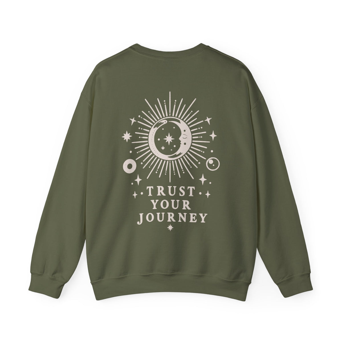 An olive green crewneck sweatshirt with a cream celestial graphic on the back featuring a sun, moon, stars, and the text 'TRUST YOUR JOURNEY'.