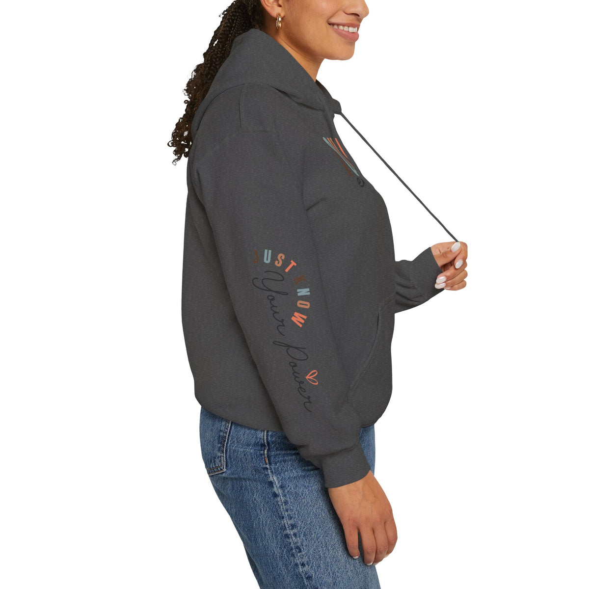Person wearing a dark gray hoodie with text graphics on the right sleeve 'Just Know Your Power', paired with blue jeans, shown from a side profile against a white background.