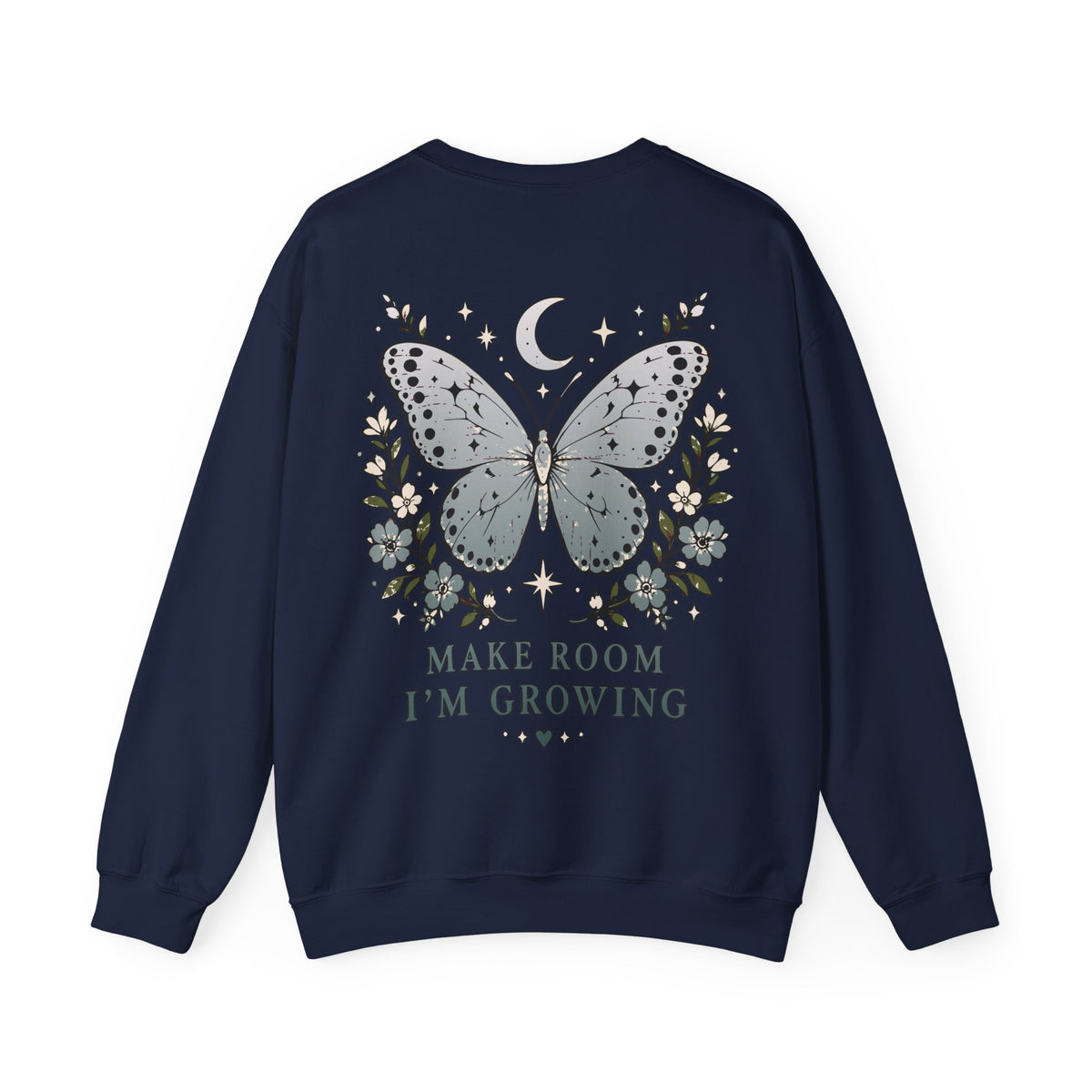A navy blue crewneck sweatshirt shown from the back, featuring a graphic of a large light blue butterfly surrounded by small white flowers, a crescent moon, and stars, with the text 'MAKE ROOM I'M GROWING' printed below.