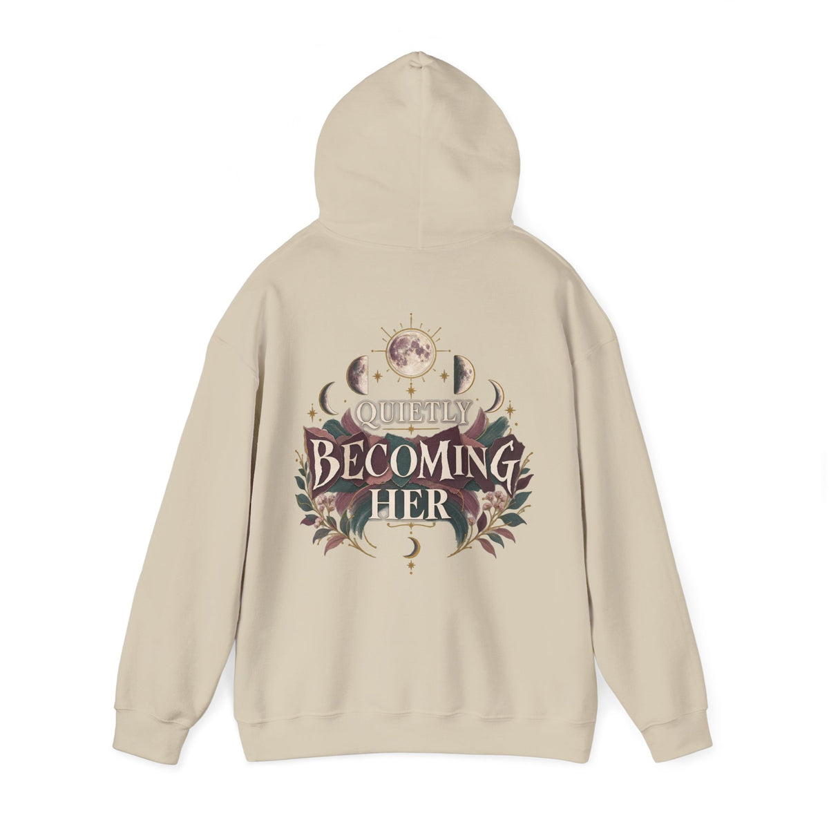 A beige hoodie shown from the back, featuring a detailed graphic print with the text 'Quietly Becoming Her' surrounded by celestial and floral illustrations.