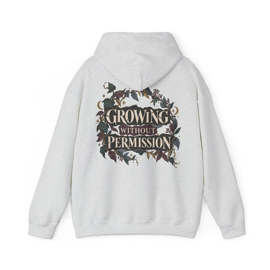 A light gray heather pullover hoodie shown from the back, featuring a large graphic print with the text 'GROWING WITHOUT PERMISSION' in a cream font, surrounded by dark foliage and floral elements.