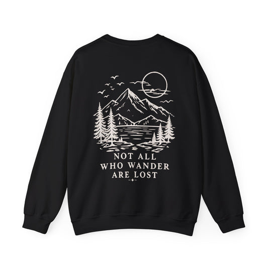 A black crewneck sweatshirt from the back with a cream graphic reading 'NOT ALL WHO WANDER ARE LOST' with a scenic route art backgrop, shown against a plain white background.