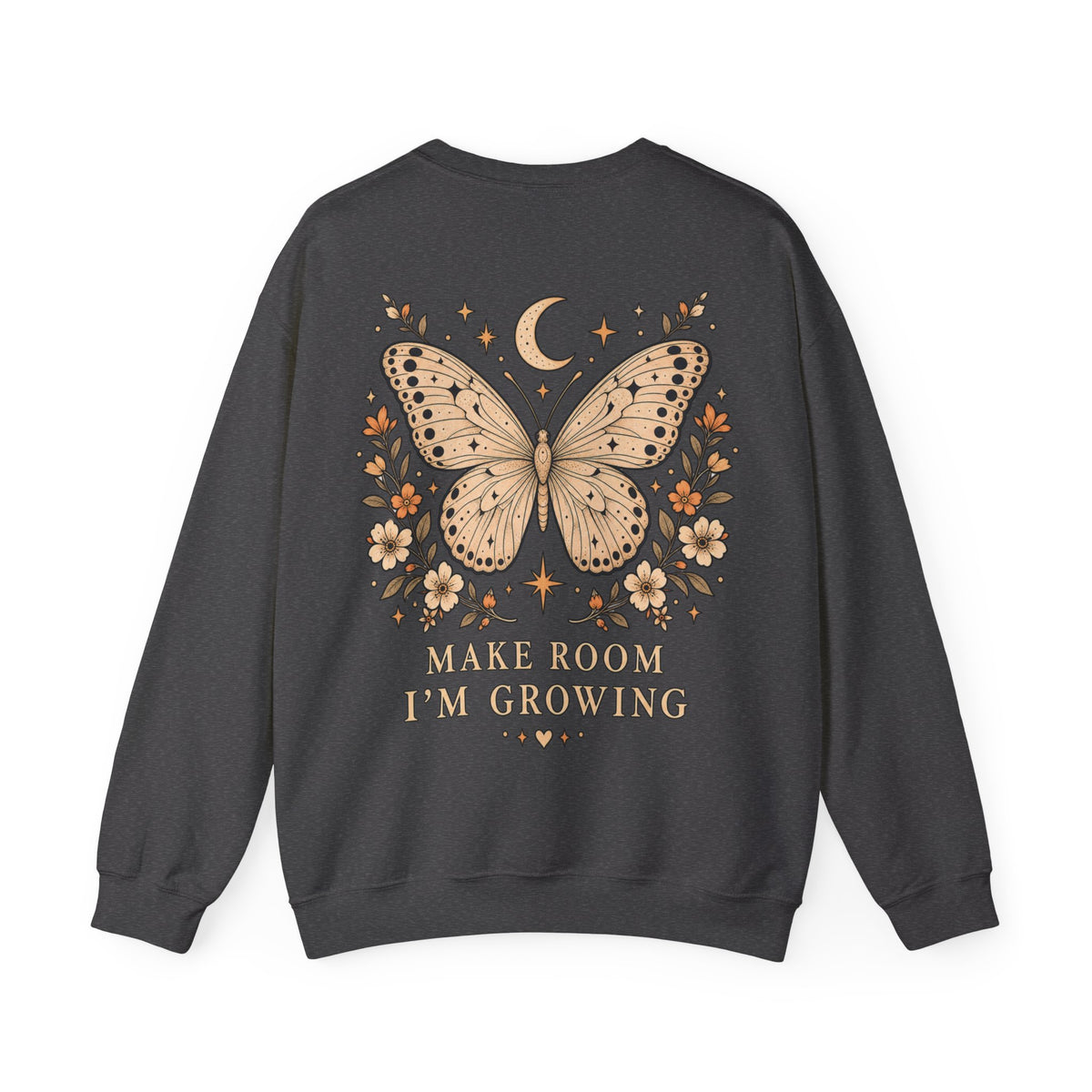 A dark charcoal gray crewneck sweatshirt shown from the back, featuring a graphic print of a beige butterfly surrounded by small flowers, stars, and a crescent moon, with the text 'MAKE ROOM I'M GROWING' printed below in a matching serif font.