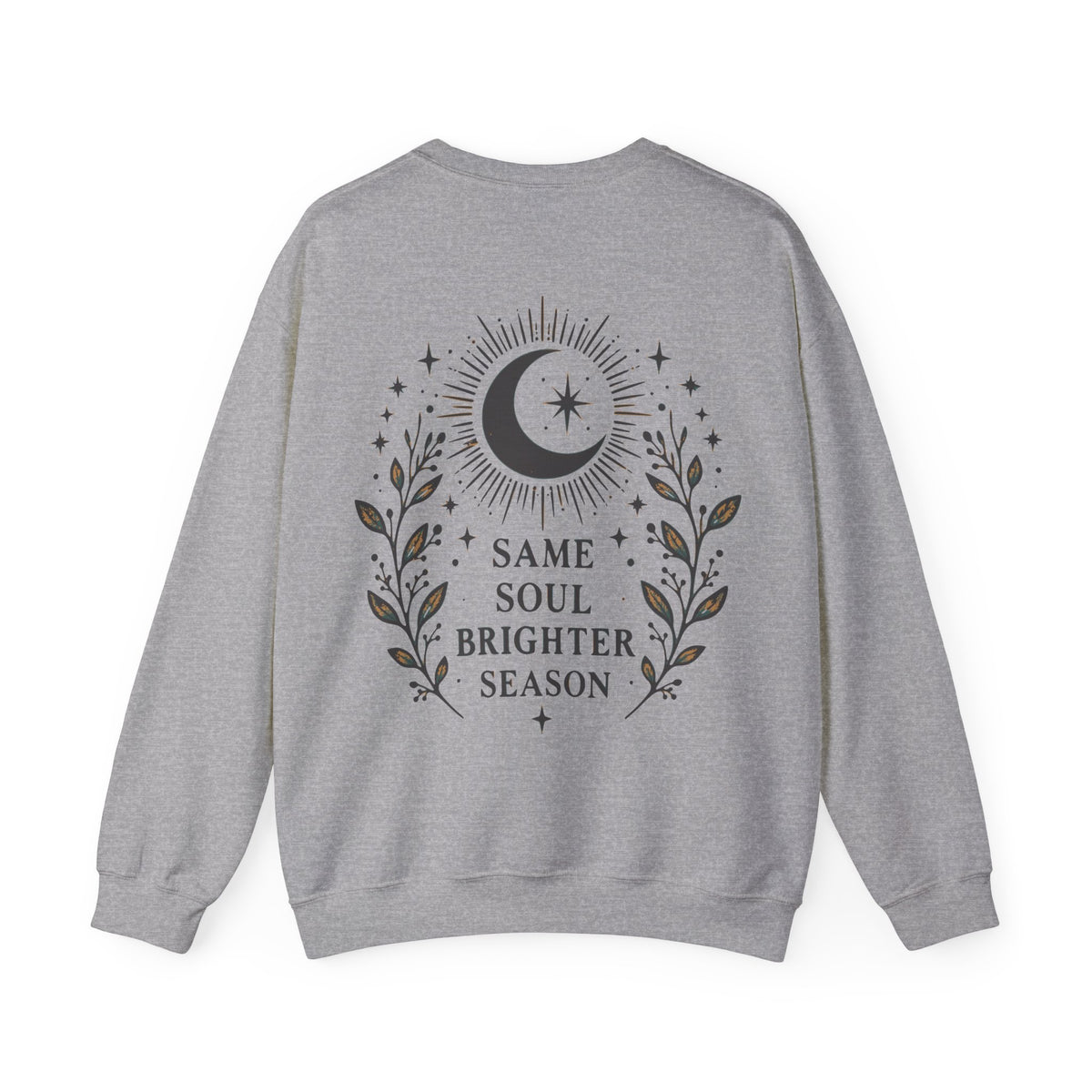A heather gray crewneck sweatshirt shown from the back, featuring a dark gray graphic of a crescent moon, stars, and leafy branches with the text 'SAME SOUL BRIGHTER SEASON'.