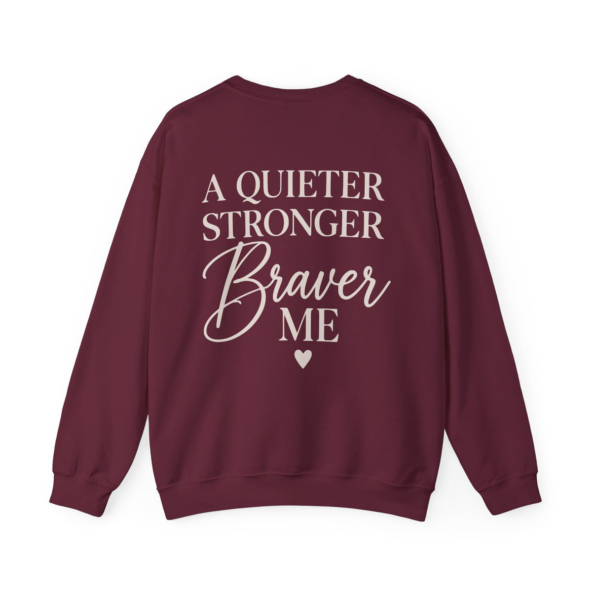 A maroon crewneck sweatshirt with long sleeves, featuring the text 'A QUIETER STRONGER Braver ME' in cream printed on the back, accompanied by a small cream heart below.