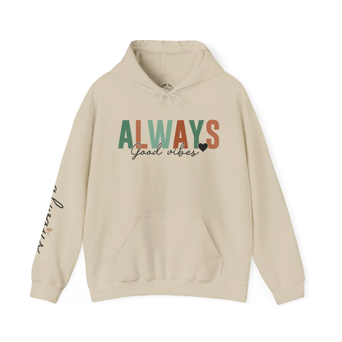 A beige pullover hoodie with a front kangaroo pocket and drawstring hood, featuring the word 'ALWAYS' in block letters with 'Good vibes' in black script underneath with a solid small heart. The left sleeve has a vertical script graphic 'ALWAYS GOOD ENERGY'.