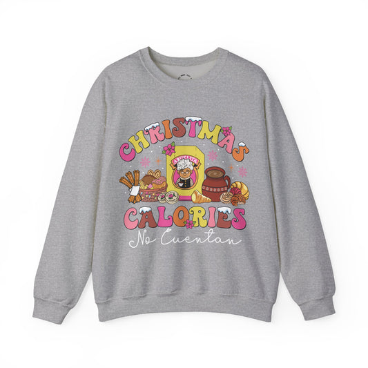 A heather gray crewneck sweatshirt featuring a colorful graphic print on the front with the text 'CHRISTMAS CALORIES No Cuentan' and cartoon illustrations of holiday treats and characters.