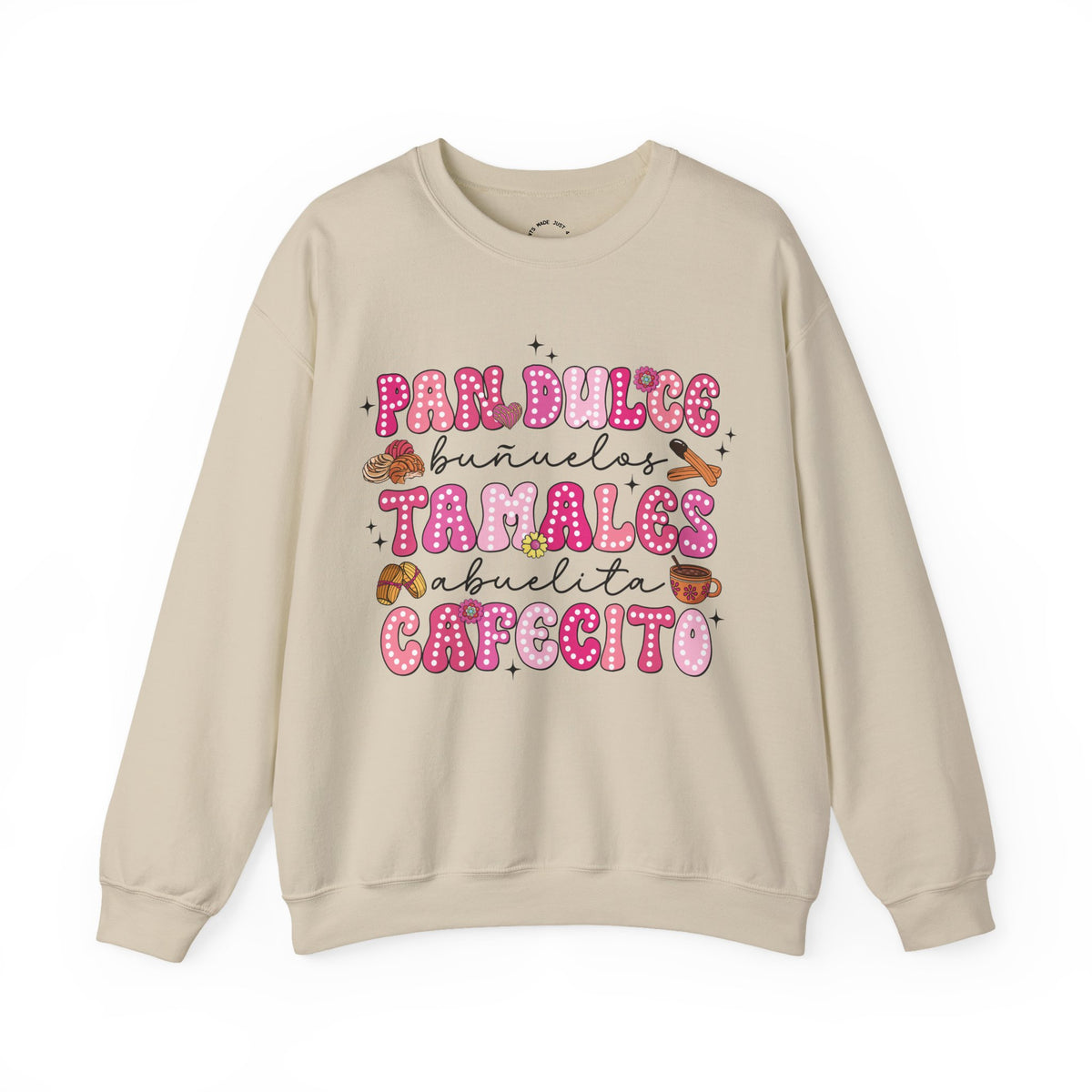 A beige crewneck sweatshirt featuring a colorful graphic print on the front with the Spanish text 'Pan Dulce Bunuelas Tamales Abuelita Cafecito' in pink and brown donut-style lettering with small illustrations of food items.
