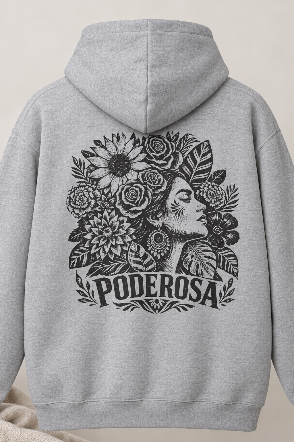 A light gray pullover hoodie shown from the back, featuring a large black graphic print of a woman's profile surrounded by flowers and leaves, with the word 'PODEROSA' written below.